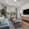 Large Living Area with ceiling fan and picture windows